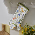Floral cottage garden gauntlet oven glove in multi-coloured print with green trim.