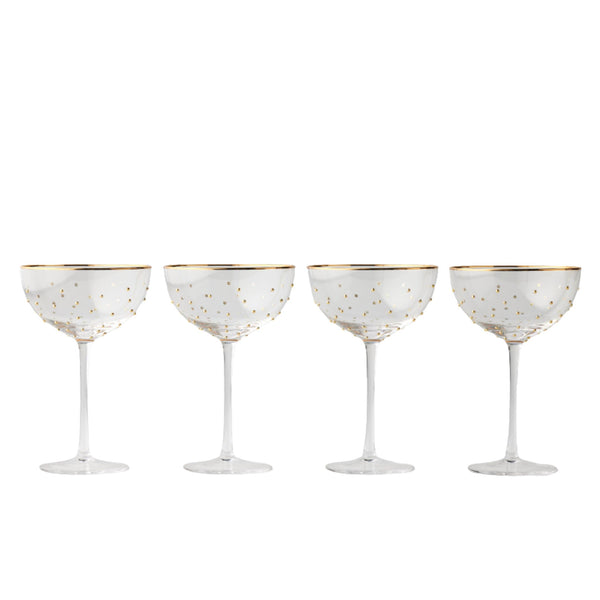 Set of four coupe glasses with raised gold dots and gold rim, elegant glassware for champagne and cocktails.