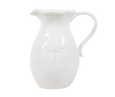 White stoneware jug with raised dragonfly detail and curved handle, styled in a coastal Hamptons interior.