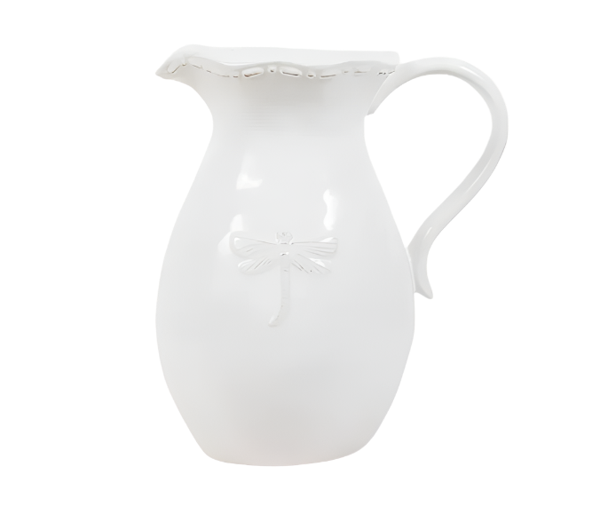 White stoneware jug with raised dragonfly detail and curved handle, styled in a coastal Hamptons interior.