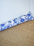 Blue and white Hamptons style draught stopper placed along a door to block cold air