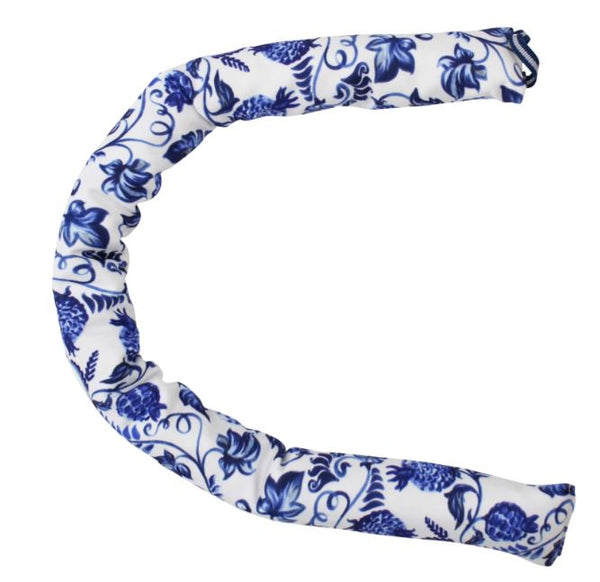 Blue and white Hamptons style draught stopper placed along a door to block cold air