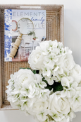 Elliot Magnifying Glass in rattan tray with white hydrangeas