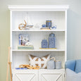 White timber bookcase styled with coastal and blue and white accents