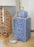 Floral blue and white ceramic canister styled on a console with coastal décor accents