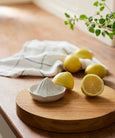 Franco white stoneware lemon squeezer styled on timber board with fresh lemons in a light-filled kitchen