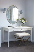 Hampton Writing Desk in white styled as a dressing table with mirror and stool in a Hamptons bedroom