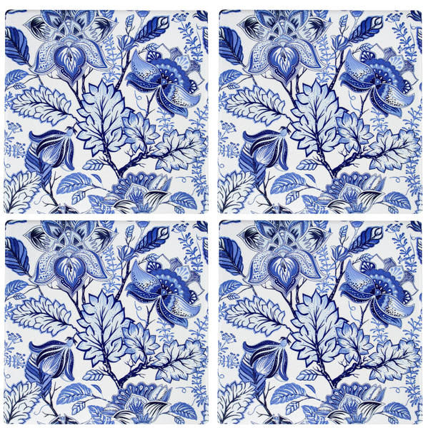 Set of four blue and white floral ceramic coasters with hand-painted design and cork backing.