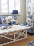 White Harbourside coffee table styled in a Hamptons living room with blue sofa and armchair