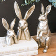 Tall Hare Sculpture Champagne styled with coordinating rabbit figurines on decorative books beneath eucalyptus foliage