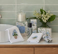 Heritage Bloom bathroom accessories styled with hydrangea embroidered face washer