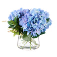 Hydrangea Nite Berry Classic Bowl Blue with lifelike blue hydrangeas, white berries and foliage arranged in a glass bowl with faux water.