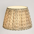 Large pleated linen lamp shade with indigo pattern illuminated