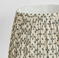 Close up of pleated lamp shade with dark blue floral linen fabric