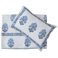 Hand block printed blue and white cotton coverlet set with matching pillow shams, folded and layered