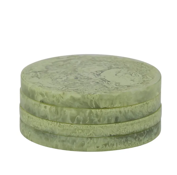 Pistachio green resin coasters with a soft marbled finish, stacked in a set of four