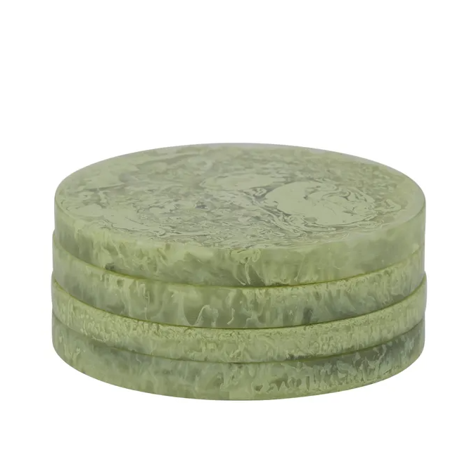 Pistachio green resin coasters with a soft marbled finish, stacked in a set of four