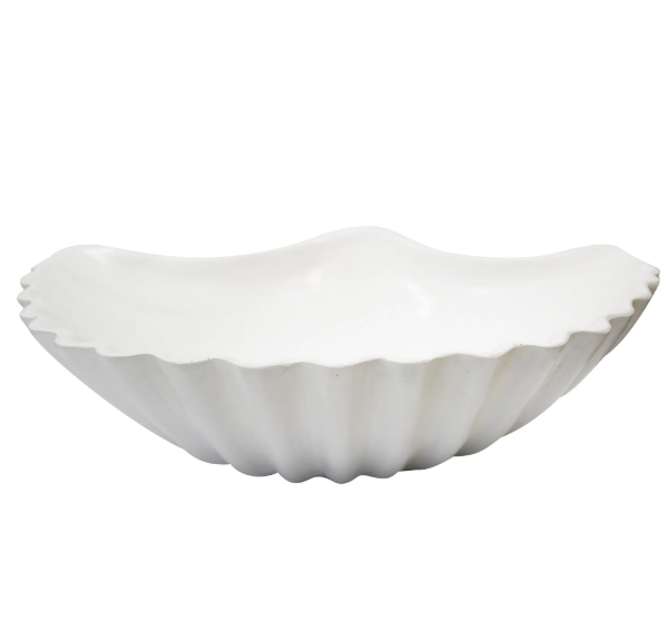 A wide, shallow, and curved decorative dish shaped like a large scallop shell. It has a ribbed texture and is a matte white colour. The dish is shown from the front.