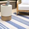 Malibu Coastal Stripe Outdoor Rug Blue styled beneath coastal outdoor furniture in a tropical entertaining area.