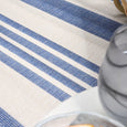 Close-up of the Malibu Coastal Stripe Outdoor Rug Blue showcasing wide and narrow blue coastal stripes.