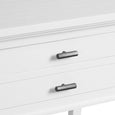 A tall, rectangular bedside table painted in a crisp white finish. It features two drawers stacked on top of an open lower shelf. The drawers have thin, streamlined black metallic handles, and the table legs are straight. Handle close up.