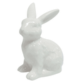 Glossy white ceramic rabbit ornament with upright ears on a white background