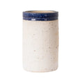 Monte terracotta pot in natural clay with dark blue glazed rim, cylindrical design on kitchen bench.