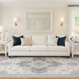 Newport Blue Rug styled in a Hamptons living room with white sofa and coastal blue accents
