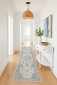 Newport Blue Rug with detailed medallion design in soft blue and ivory tones in hallway of a coastal home.