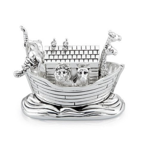 A silver-plated musical box figurine shaped like Noah's Ark, resting on stylized waves. Animals, including a lion, raccoon, and giraffes, are visible in the ark, with Noah hanging off the side. The overall finish is shiny silver.