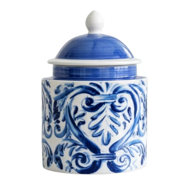 Blue and white ceramic lidded jar with hand-painted scroll design styled on a bathroom countertop.