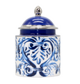 Blue and white ceramic lidded jar with hand-painted scroll design styled on a bathroom countertop.