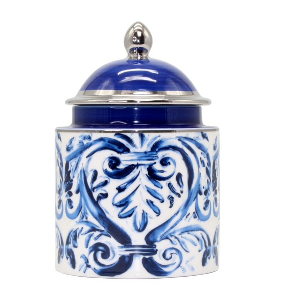 Blue and white ceramic lidded jar with hand-painted scroll design styled on a bathroom countertop.