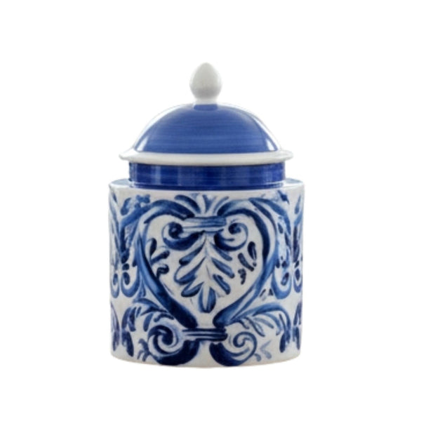 Blue and white ceramic lidded jar with hand-painted scroll design styled on a bathroom countertop.