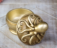 Gold octopus-shaped decorative box with removable lid, featuring a sculpted octopus design atop a round resin container.