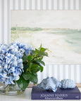 Close-up of blue hydrangea flowers with green leaves in glass bowl arrangement