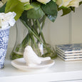 White ceramic bird trinket dish styled on Hamptons shelving with a floral arrangement