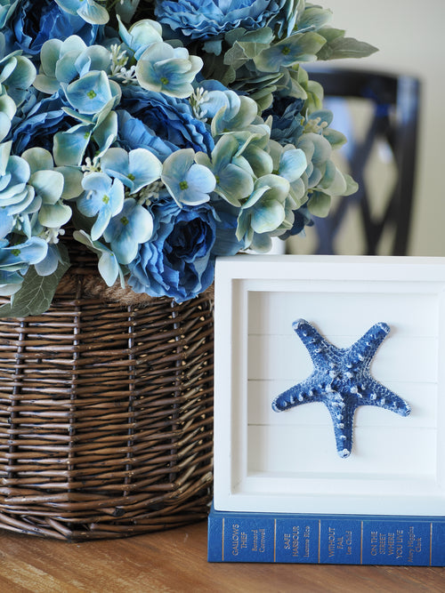 White framed starfish wall art with textured coastal design