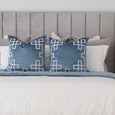 Palm Springs vintage blue velvet cushion styled on a bed with white embroidered detailing in a Hamptons bedroom setting