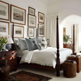 Paloma Tennis Stripes Cushion 55cm in green-and-white cotton stripes with embroidered tennis racquets and PLH crest motif on bed with other complimentary cushions.