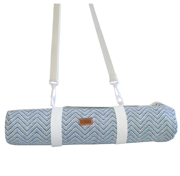 Foldable blue and white chevron picnic mat with white carry straps, rolled up for easy transport.