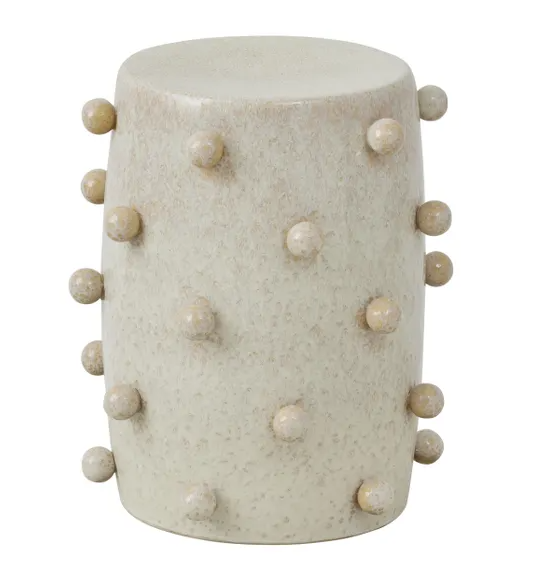 Ivory ceramic stool with raised pip detailing and rounded drum shape.
