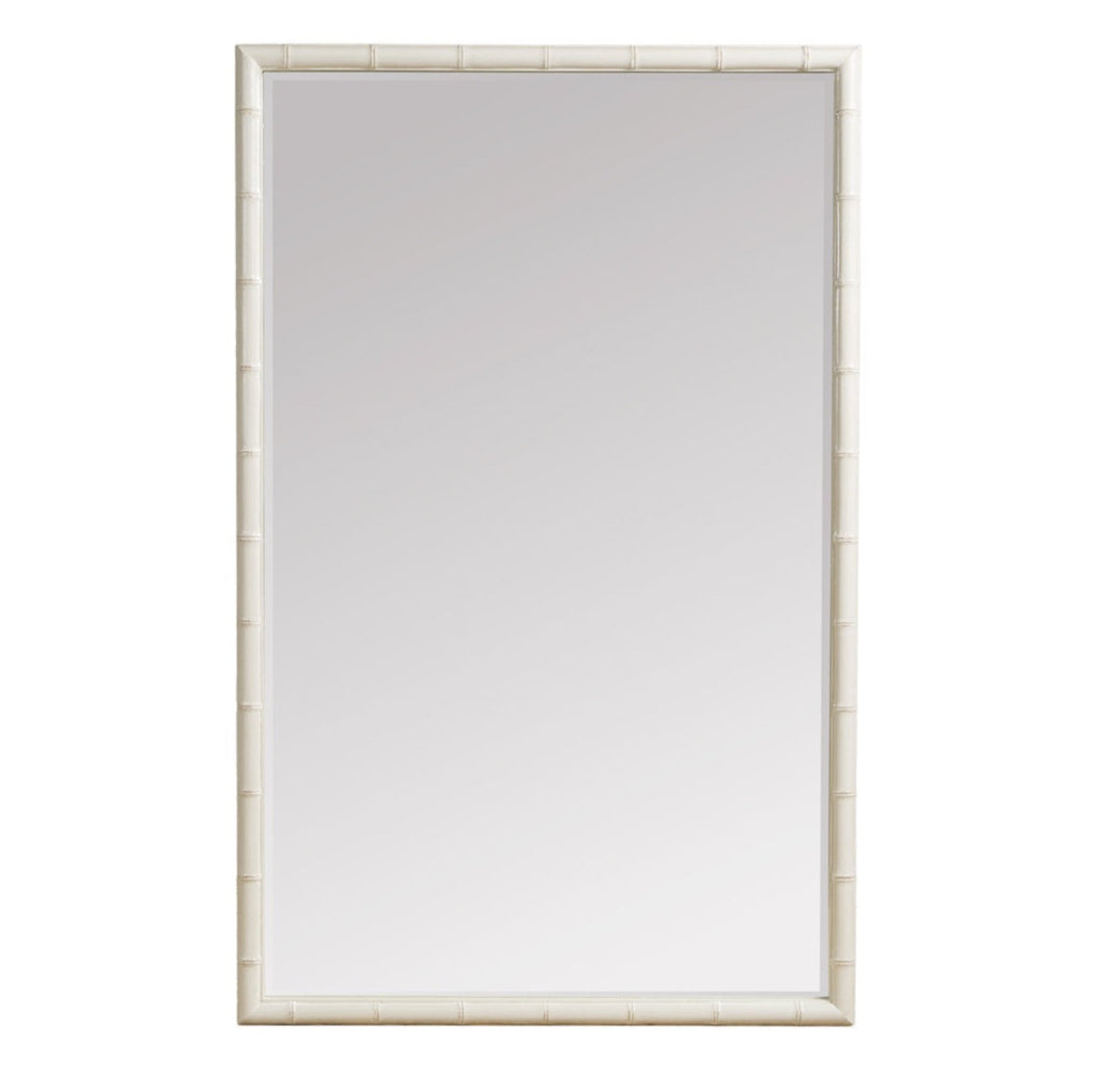 A tall, rectangular mirror with a wide, decorative frame. The frame is finished in a soft off-white and features a raised, textured pattern that resembles bamboo or rattan rods running vertically.