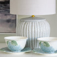 blue ceramic table lamp styled with hydrangea bowls