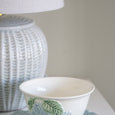 blue ceramic lamp styled with decorative bowl and coastal accessories