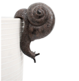 Brown resin snail pot sitter hanging over the edge of a planter.
