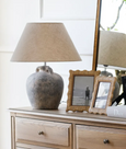 Rattan_Wavy_Photo_Frame_4x6_hamptons_style on a chest of drawers with a lamp