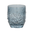 Blue glass tumbler with embossed coral reef pattern styled for a coastal Hamptons-style table