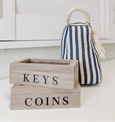 Navy and white striped door stop with a rope handle and tassel detail, adding a stylish nautical touch to coastal-inspired interiors.