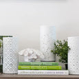 white porcelain lamps styled on shelf with books and greenery hamptons coastal lighting decor